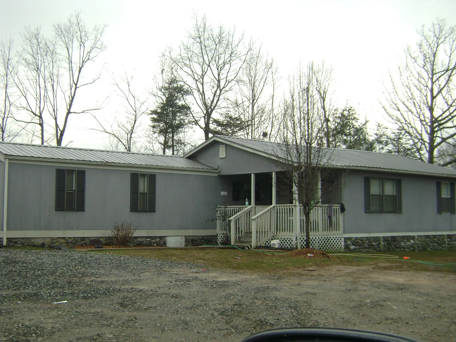Metal roof over a manufactured home with a covered front porch in Sheyenne